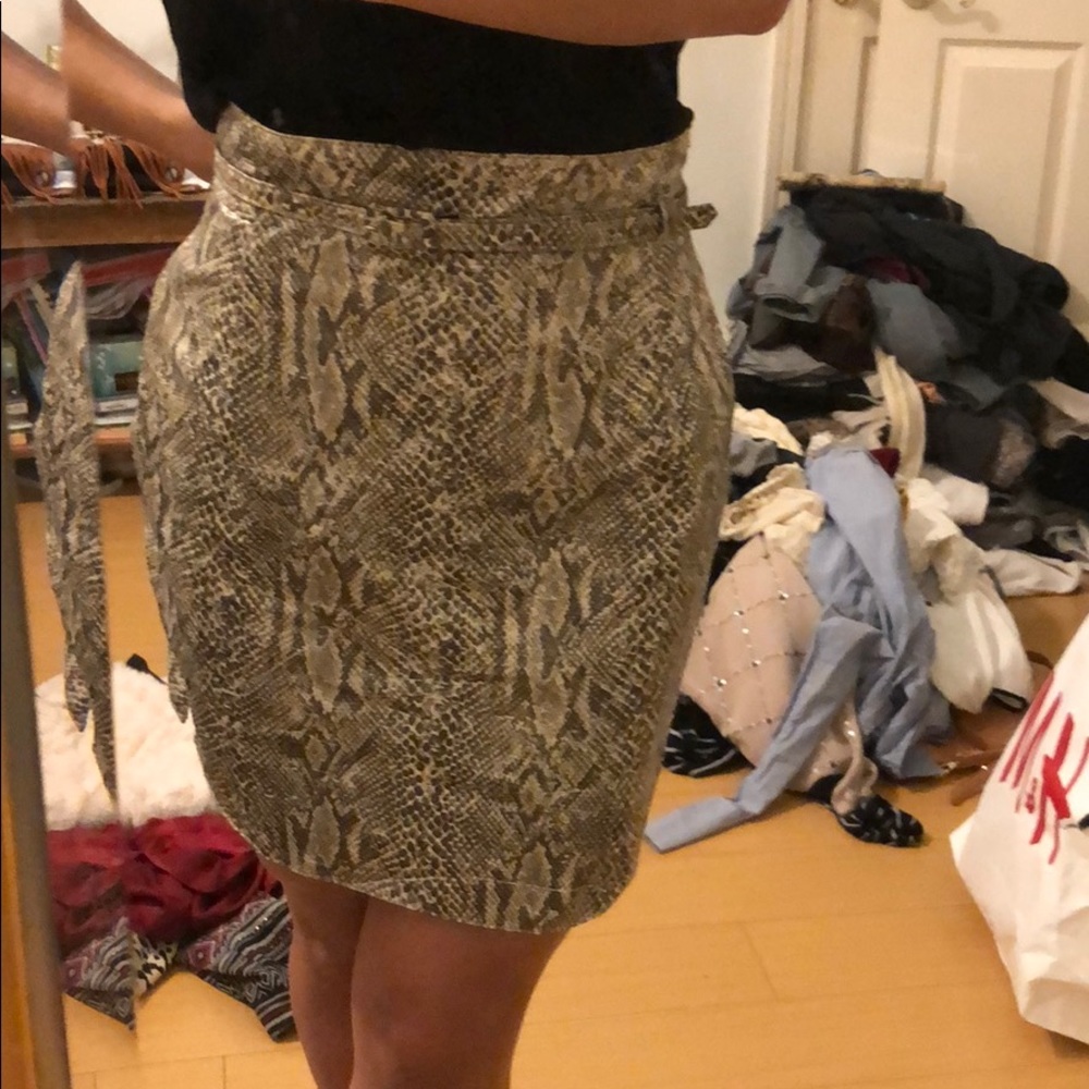 Snake skin print skirt with matching belt.